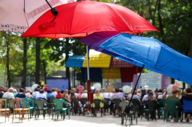 Colorful shadows on blurred background people at an outdoor conference meeting
