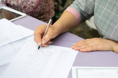 Woman's hand writes an activity plan