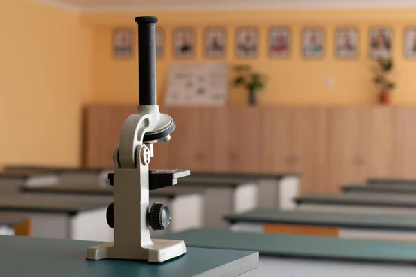 School microscope in chemistry on the table in the laboratory class at school