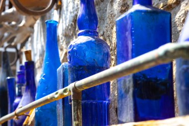 blue glass bottles set on a shelf