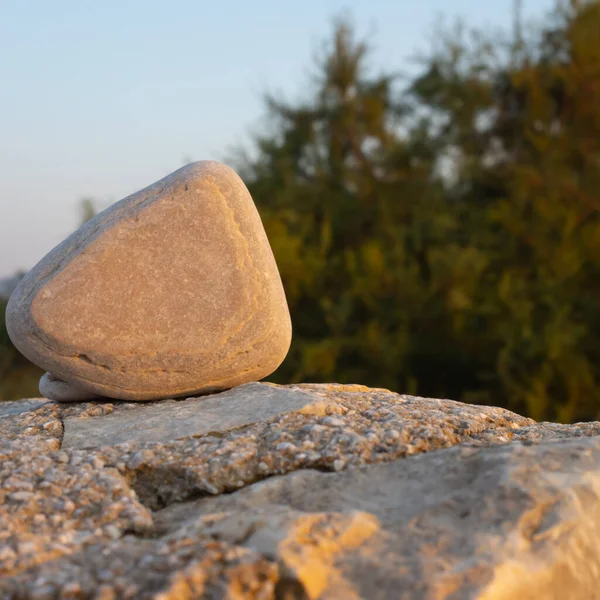 three-fold stone on a concrete wal