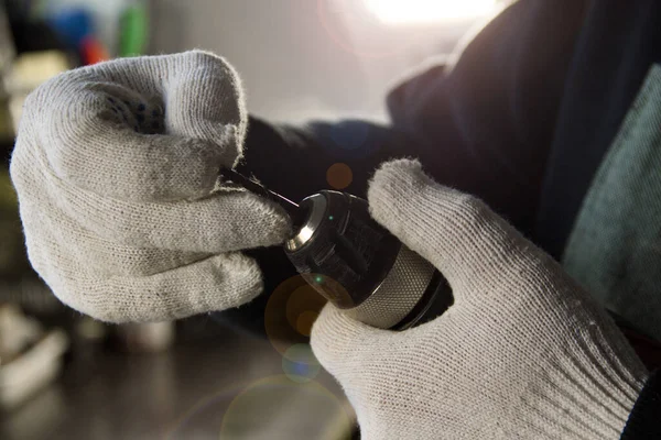 Erkek eller matkabın içine matkap sokuyor. Marangozluk işi.