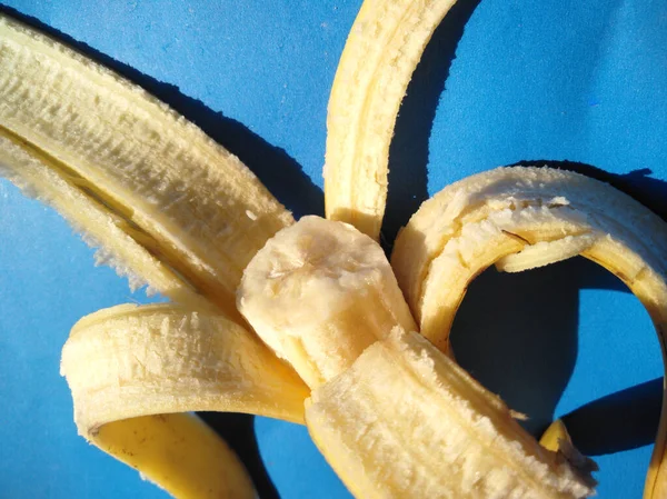 bananas on a blue background.cold tone.Classification of bananas Kingdom Plantae, Division Magnoliophyta, Class Liliopsida, Order Musales, Family Musaceae, Genus Musa, Species Musa paradisiaca