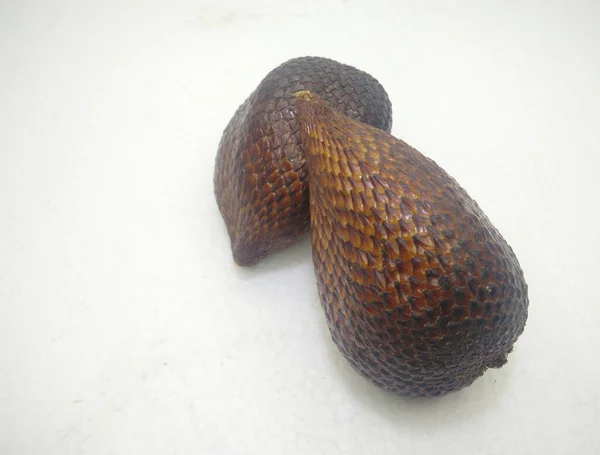 snakefruit isolated on a white background. Salacca zalacca.normal angle view.The bark of the salak fruit contains compounds that can treat diarrhea quickly. Salak is rich in potassium which makes the heart healthier.
