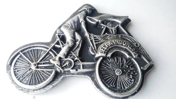 refrigerator magnet in the form of a rickshaw, pedicab is one of the means of transportation in Indonesia. fridge magnet isolated on a white background.high angle view.
