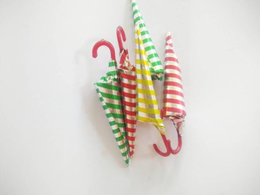 chocolate shaped like an umbrella wrapped in aluminum foil with a strip motif. isolated on a white background.close up.