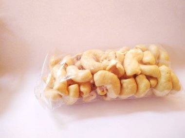 macaroni pasta wrapped in transparent plastic isolated on a white background. normal angle view.