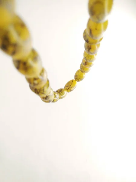 Round beads like marbles are often used for worship and/or after Muslim prayers, rosary beads isolated on white background.