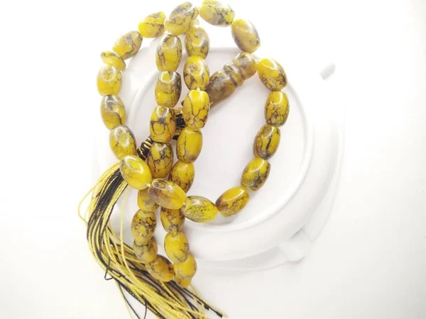 Round beads like marbles are often used for worship and/or after Muslim prayers, rosary beads isolated on white background.