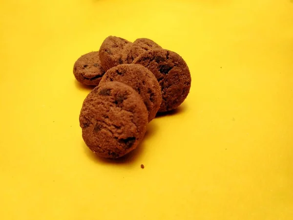 mini chocolate chip cookies on yellow background. for backgrounds, covers, banners and more.