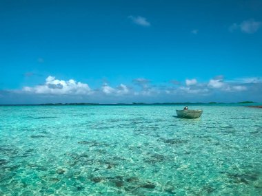 Turquoise sea water island landscape. Blue sky and fishing boat. Beautiful tropical beach abstract texture background. Exotic summer resort, vacation, paradise holiday travel concept. Relaxing nature