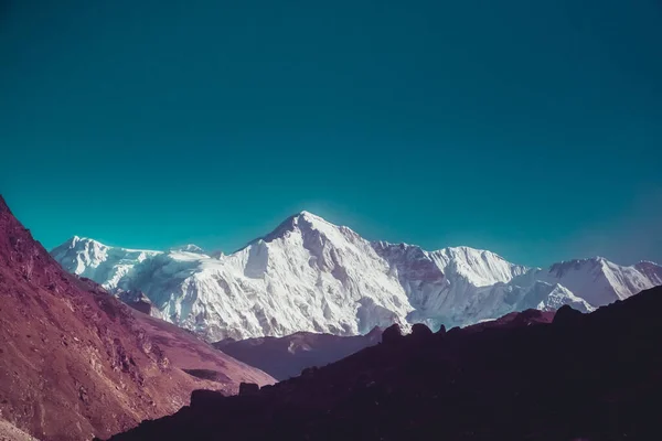 Snowy mountain peak in Himalaya mountain national park. Trekking, sports, active lifestyle. Panoramic landscape nature background. Vintage retro tone filter