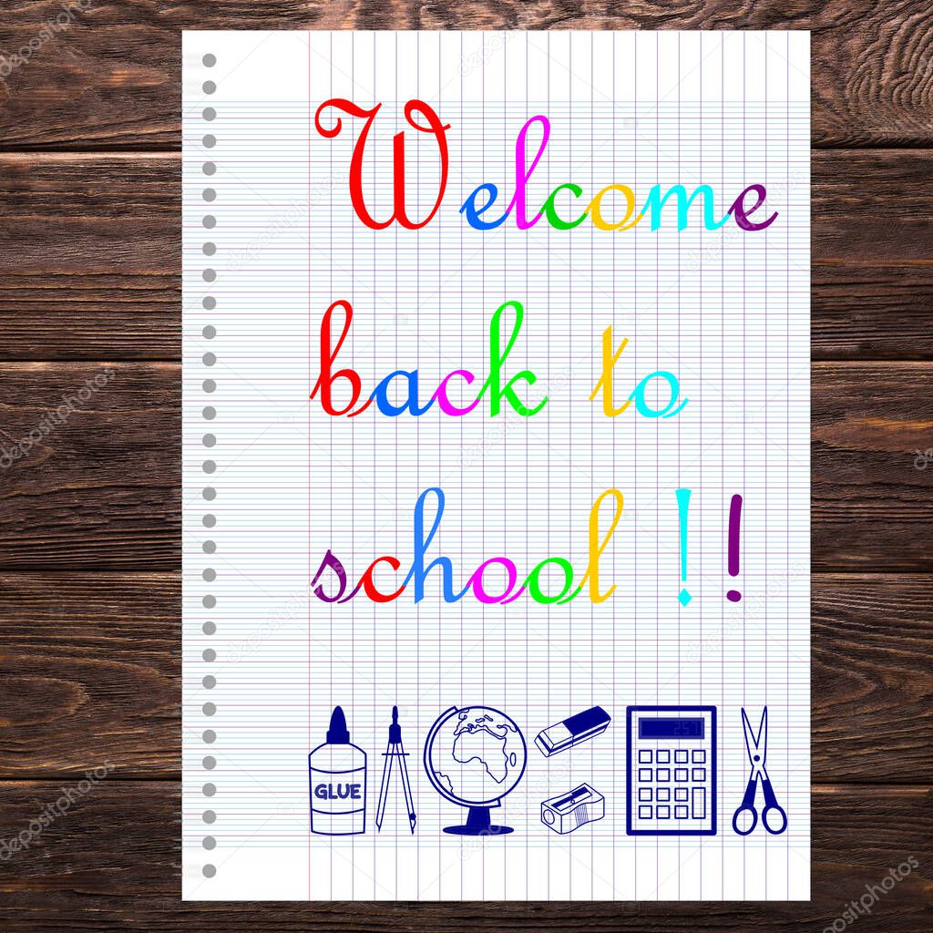 Welcome back to school written in English on a sheet of school notebook with scissor, calculator, compass, eraser