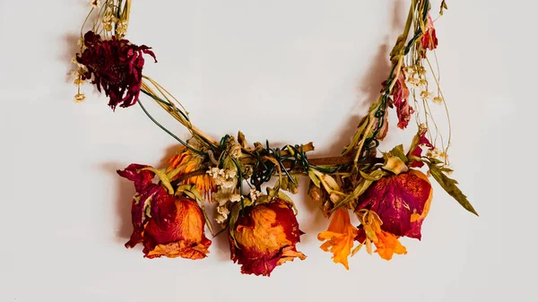 dried roses and other flowers on a headband