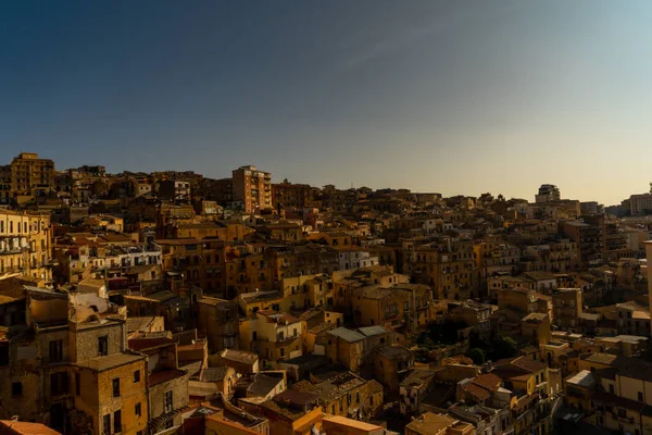 a golden sunset shining over the historical city Agrigento