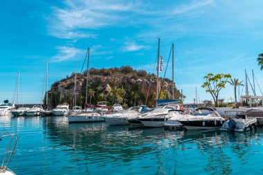 La Herradura, Granada, Spain - March 08 2022: Bay area situated in la provincial de Granada. Beautiful harbour with luxury yachts docked in a small bay. All the dock area surrounded by restaurants