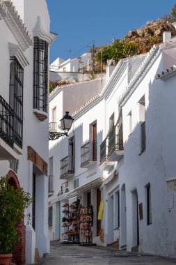 Streets of Frigiliana village. Beautiful white houses and small streets. Typically Andalusian town. Touristic travel destination on Costa del Sol. Vertical photography.
