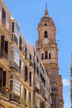 Malaga, İspanya - 21 Nisan 2022: Malaga sokakları. Eski Malaga küçük caddeleri, dükkanları ve restoranları olan gezinti alanı. Arka planda Malaga Katedrali 'nin güzel kuzey kulesi. 