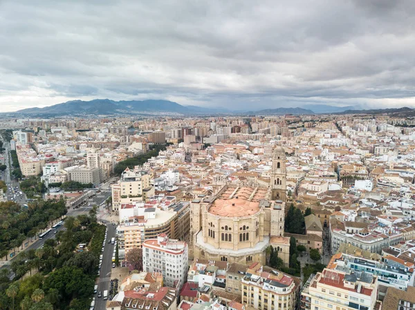 Aerial drone perspective of Andalusian city Malaga, touristic travel destination on Costa del Sol. Roof top , Cathedral of Malaga, Mountains in background, cloudy day