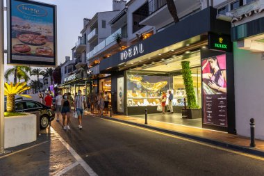 Marbella, SPAIN - July 16 2020: Puerto Banus Harbour in Marbella City. One of the most expensive and exclusive area of Marbella. Night photography of the night lifestyle with shopping area and bars
