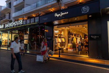 Marbella, SPAIN - July 16 2020: Night photography in luxury and famous location of Marbella -Puerto Banus  Bay. View of LOUIS VUITTON Store, in the shopping area of the harbour. Luxury lifestyle
