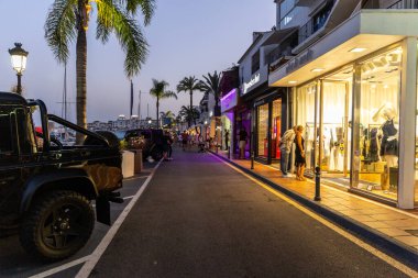 Marbella, SPAIN - July 16 2020: Puerto Banus Harbour in Marbella City. One of the most expensive and exclusive area of Marbella. Night photography of the night lifestyle with shopping area and bars