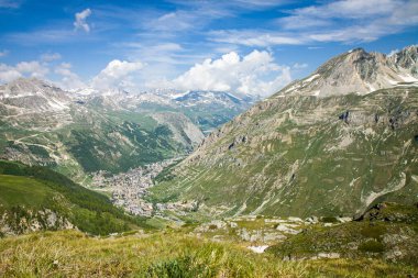 Beautiful panoramic view of Val d'Isere France - captured from Col de l'Iseran road. Savoie in the French Alps. Amazing sunny day. City in the valley. Green background HD. Perfect Wallpaper 4k.