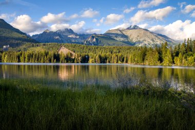 Beautiful panoramic view of mountain lake in National Park High Tatras. Strbske pleso, Strbske lake, Strba, Slovakia, Europe. High Tatras mountains national park at sunset. HD background, 4k