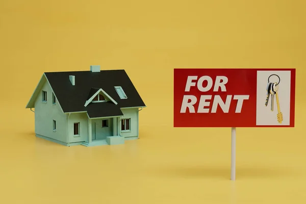 house rental concept. the house next to which the sign is for rent on a yellow background. 3d render.
