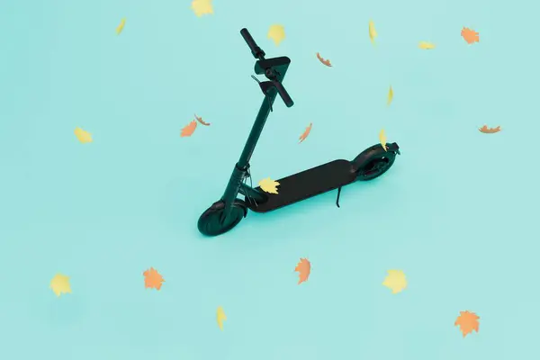 movement on an electric scooter. an electric scooter around which leaves scatter on a blue background. 3D render.