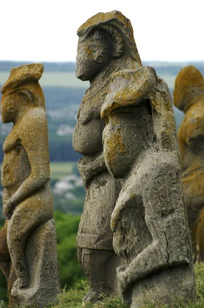 Ancient Ukrainian stone statues witn a fimale silhouette on top of a mountain