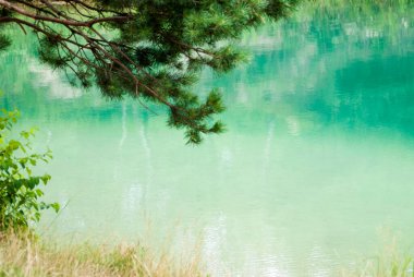 Beautiful Ukrainian lake at the base of which is a clay quarry on a summer day