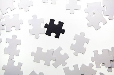 Black and white puzzle pieces on white background