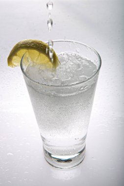 Refreshing gin tonic on white background