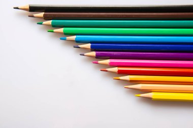 Wooden pencils of different colors on white background