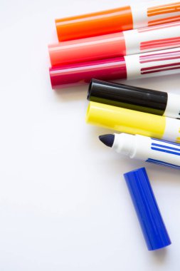felt-tip pens of different colors on white background