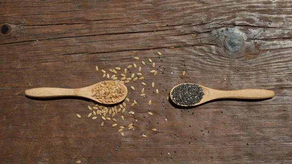 Two Wooden Spoons Seeds Wooden Background — Stock Fotó