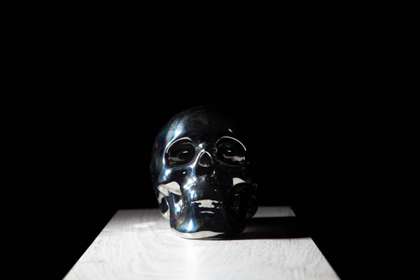 Gray color skull on black color background