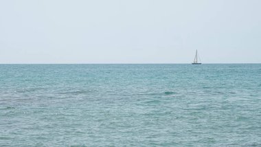 Mediterranean sea with a sailboat sailing