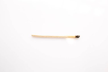 Small burnt wooden matches on white background