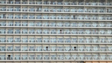 Balconies of the cabins of a large cruise ship moored in the port