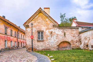 Historic Building In Stone And Bricks With Old Windows