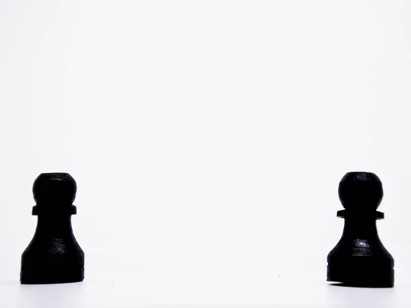 the pawn character in this chess game are made in the traditional way, using coconut wood and colored in black