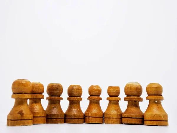 the pawn character in this chess game are made in the traditional way, using coconut wood and colored in brown