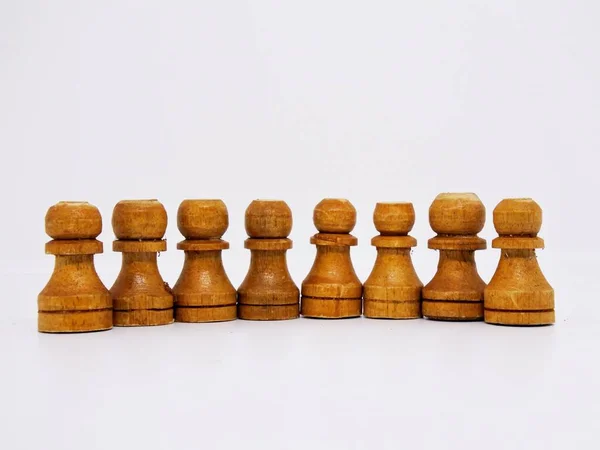 the pawn character in this chess game are made in the traditional way, using coconut wood and colored in brown