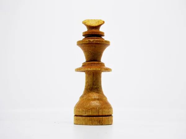 the king character in this chess game are made in the traditional way, using coconut wood and colored in brown