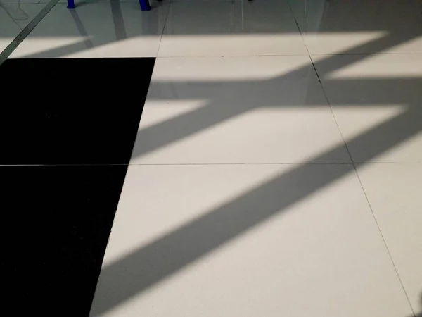 the reflection of the sun on a sunny morning casts a unique shadow on the interior of a waiting room in a hospital on a sunny morning