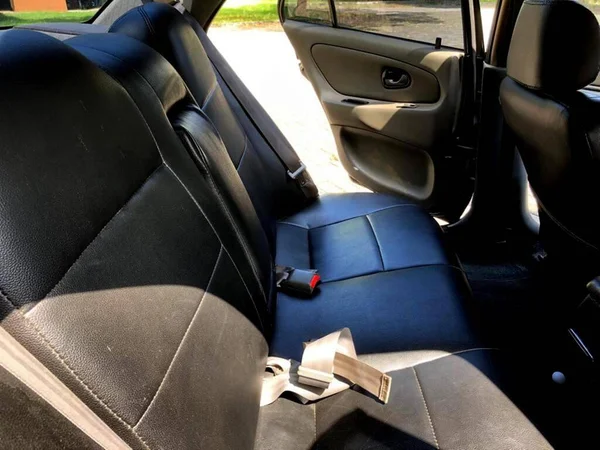 the interior of an old car that is kept clean because it is always routinely maintained by the owner