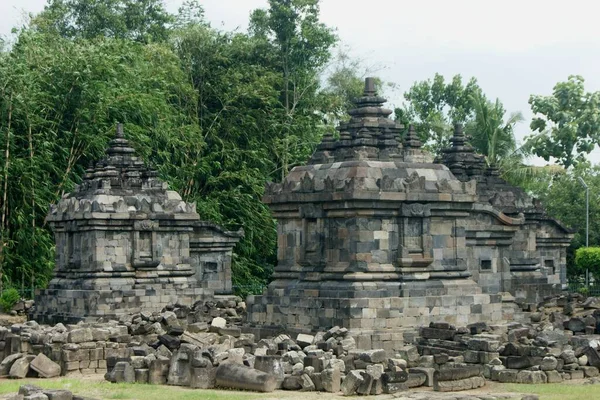 a small temple building that stands tall and strong among the messy stone temple structures that will be arranged to become part of the existing temple