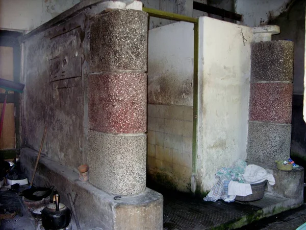 bathroom of an old house side by side with a shabby kitchen and poorly maintained by the owner